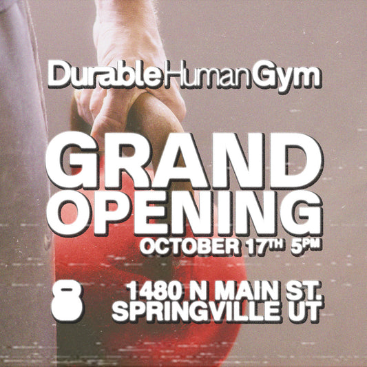 Advertisement for Durable Human Gym grand opening with a hand holding a red object.
